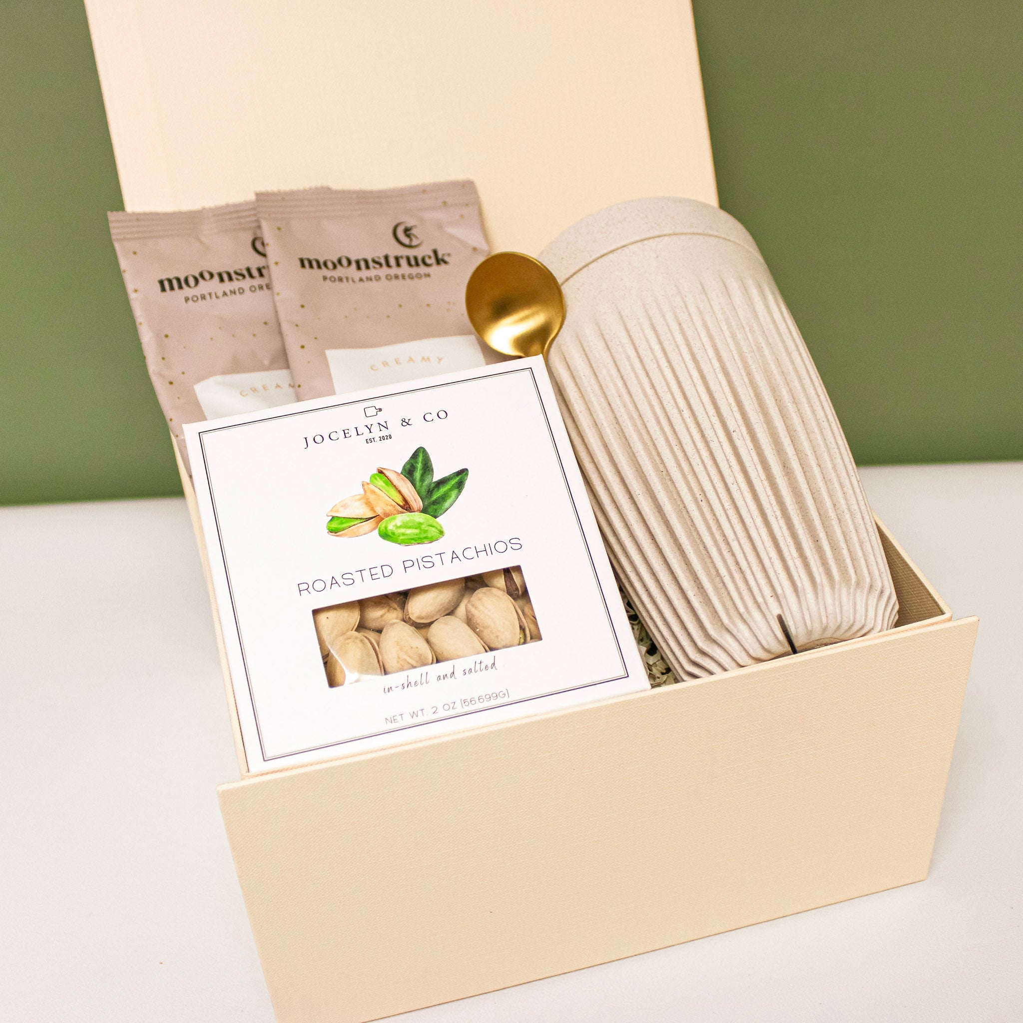 Luxury gift box with tumbler, pistachios and cocoa, perfect for holiday corporate gifts.