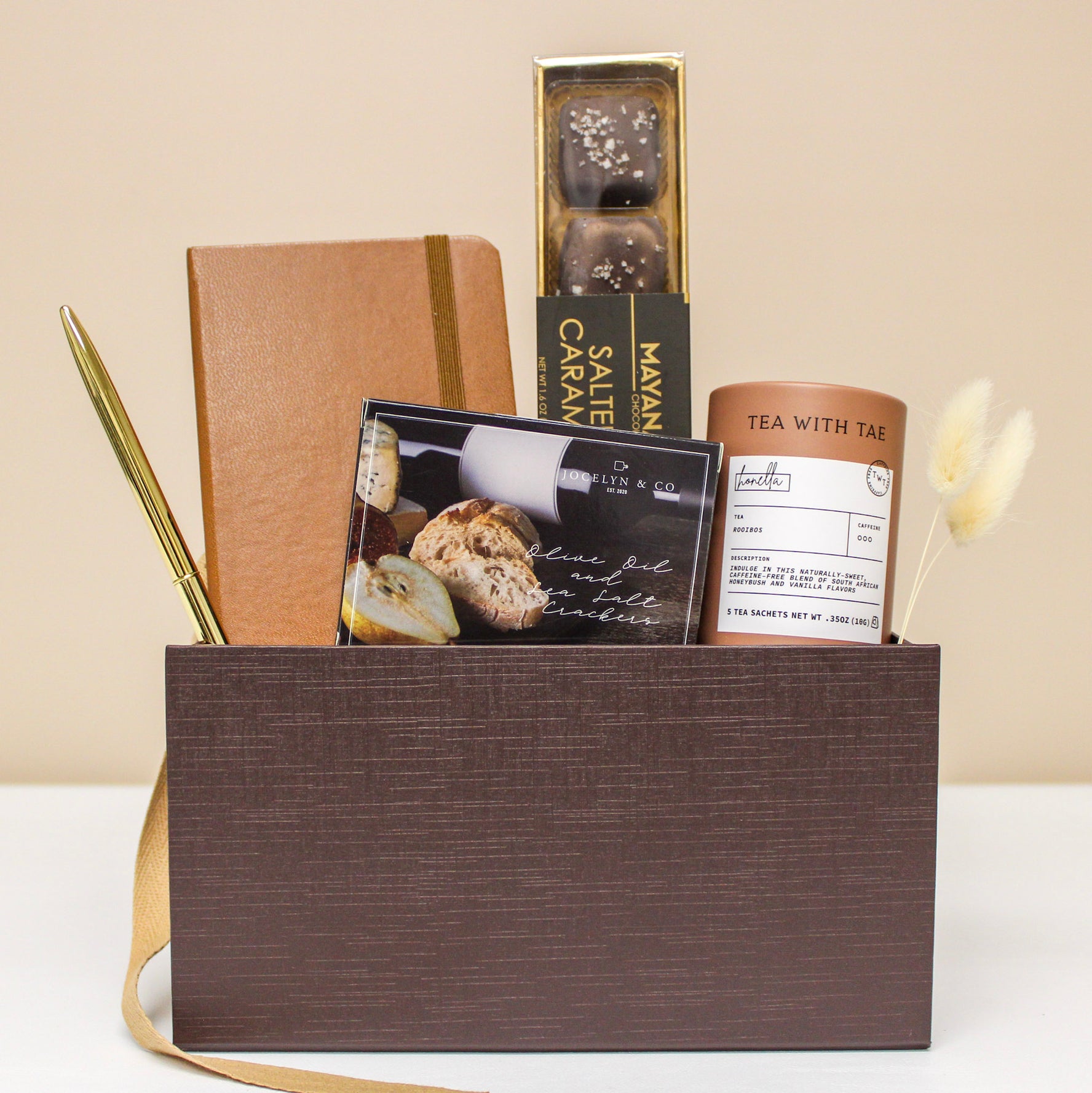 Luxury Gift Box with tea, caramels, crackers a pocket journal and pen.