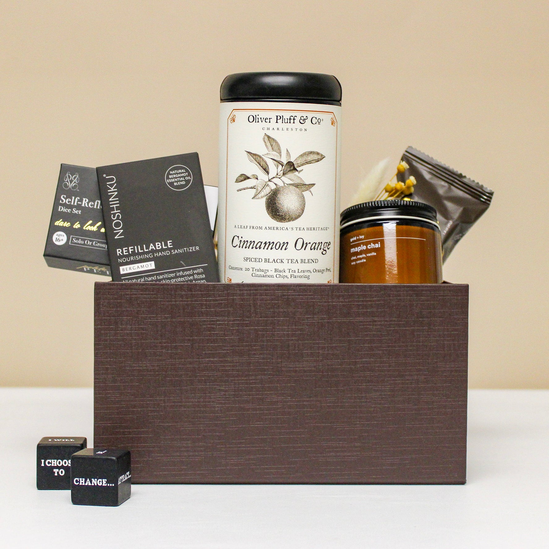 Luxury client or employee gift box with tea, candle, chocolate, hand sanitizer and self reflection dice. 